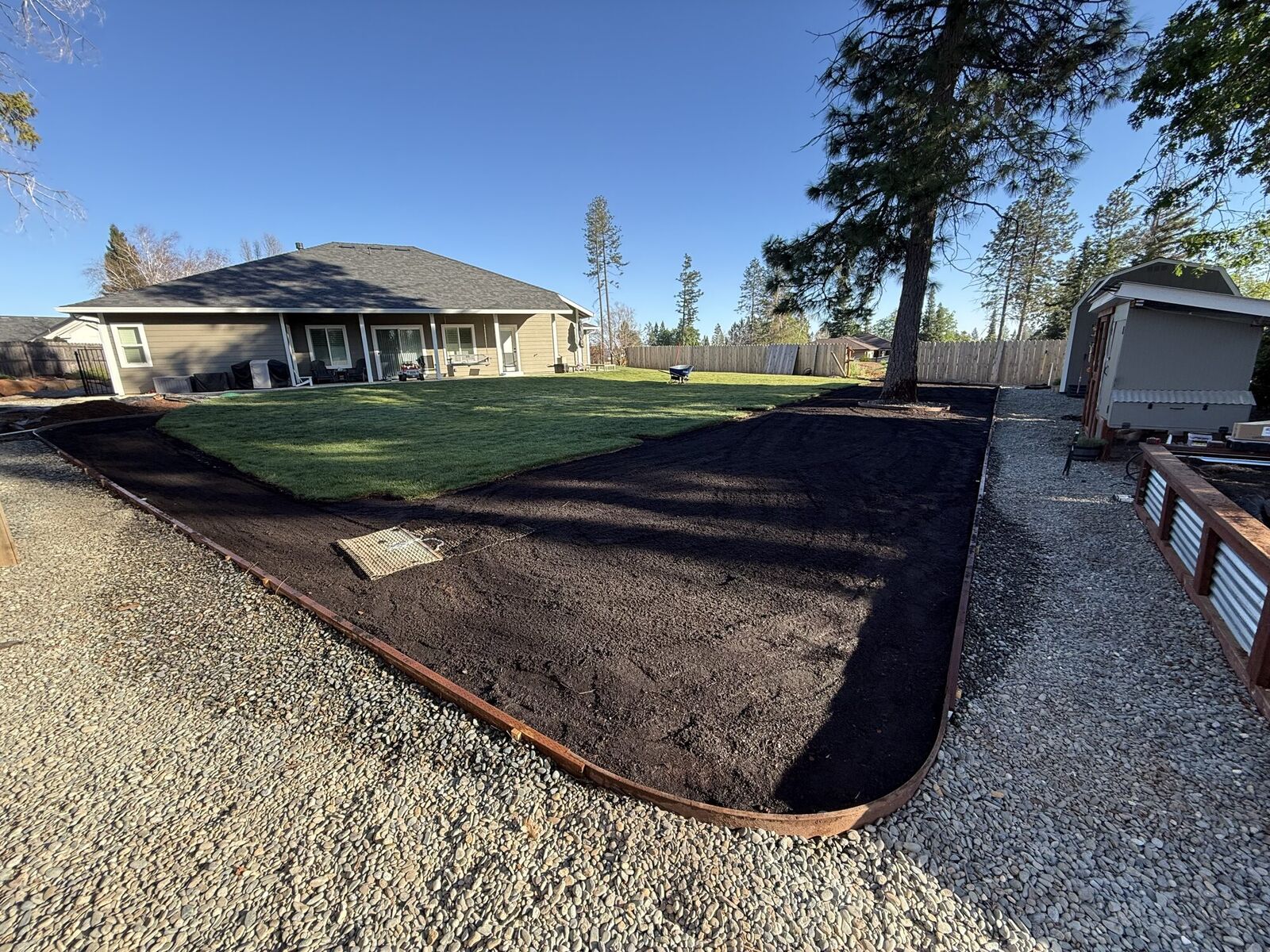 Backyard soil preparation with wood edging before lawn
