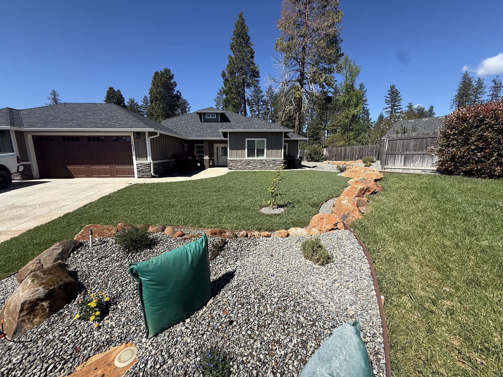 Finished front yard with dry creek bed, boulders, rock, and new plantings
