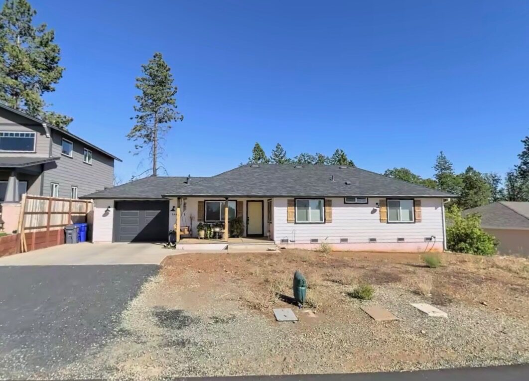 Ranch home front yard with bare gravel before landscaping